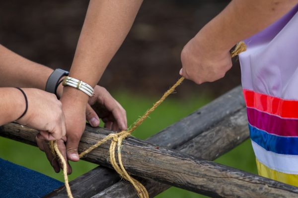 people setting up a teepee