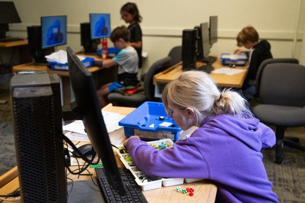 Student playing with Legos