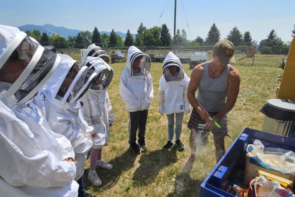 Instructor with students in bee suits at the Apiary  