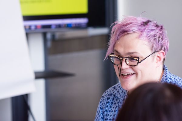 Person with wild glasses talking to someone