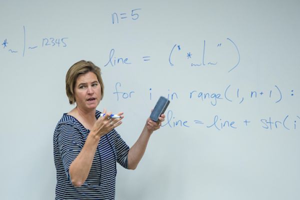 yolanda reimer points to an equation on a white board