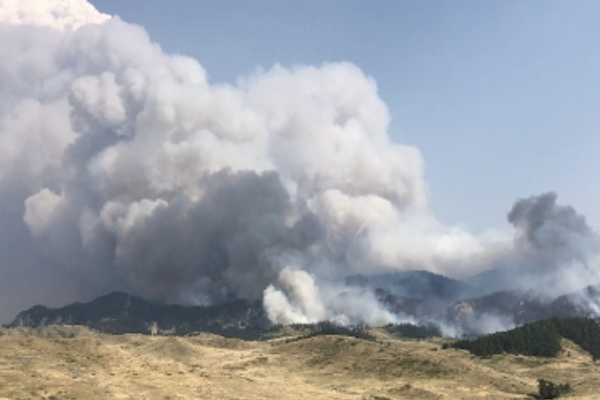 Smoke rises over the ridge during the Pine Grove Fire.