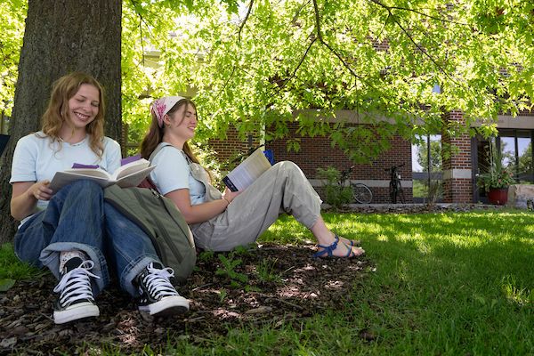 two students under a tree