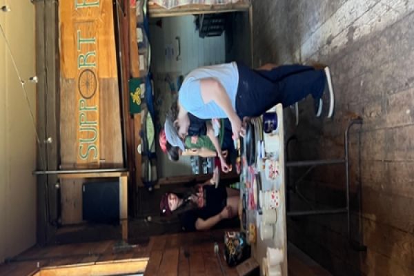 Adults gathered around a table with food 