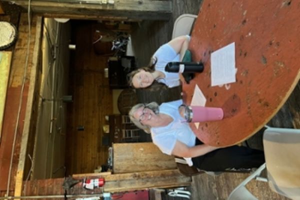 Two Adults sitting at a table and smiling at the camera