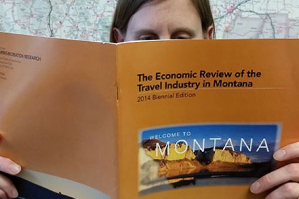 headshot of someone reading economic review of the tourism industry in ؿ