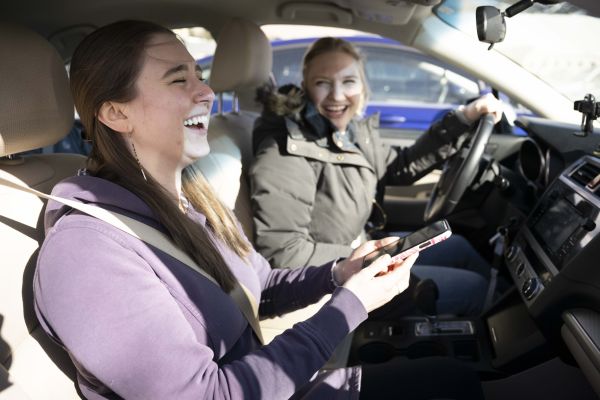 two women in a car smiling
