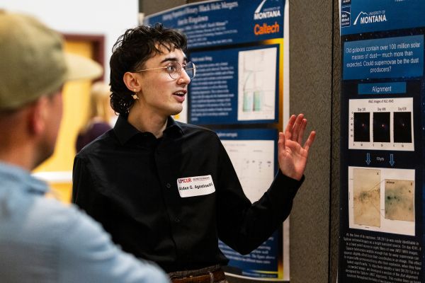 student presenting a poster at the undergraduate research conference