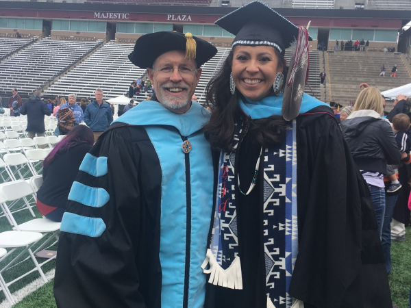 faculty with student on graduation