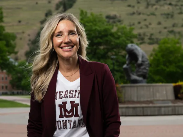 Michelle smiles for a portrait wearing University of Montana apparel