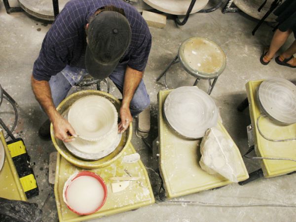 um student working at a ceramics table