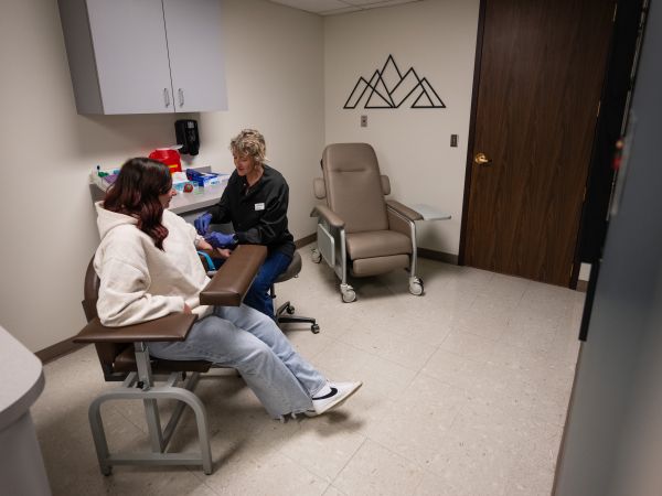 Student receives care in the Curry Health Center lab with a lab specialist.