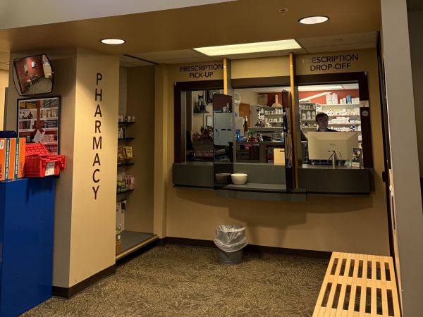 Pharmacy counter inside Curry Health Center with staff available to assist students and community members.