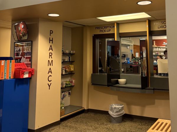 Pharmacy counter inside Curry Health Center with staff available to assist students and community members.