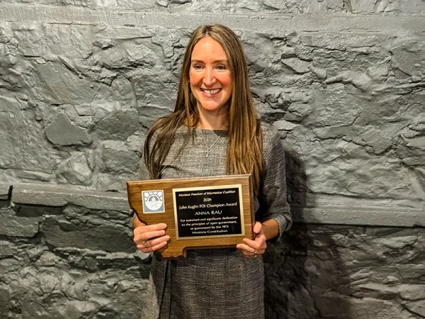 anna holding an award