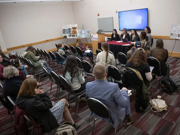 a guy holding a plate with food in front of him