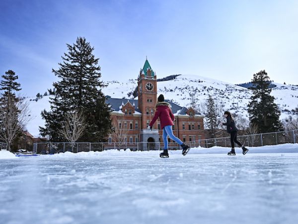 students ice skating in front of main hall
