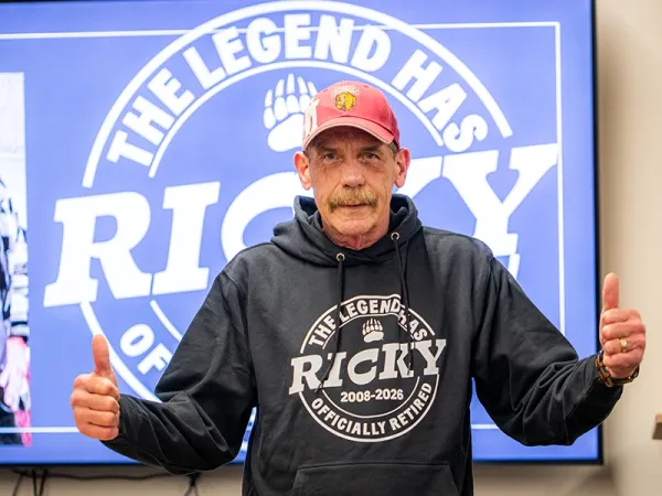 Chef Rick in front of a retirement announcement