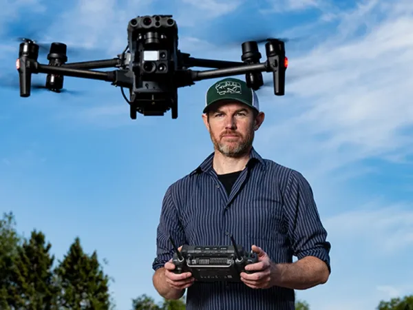 A graduate student flying a drone