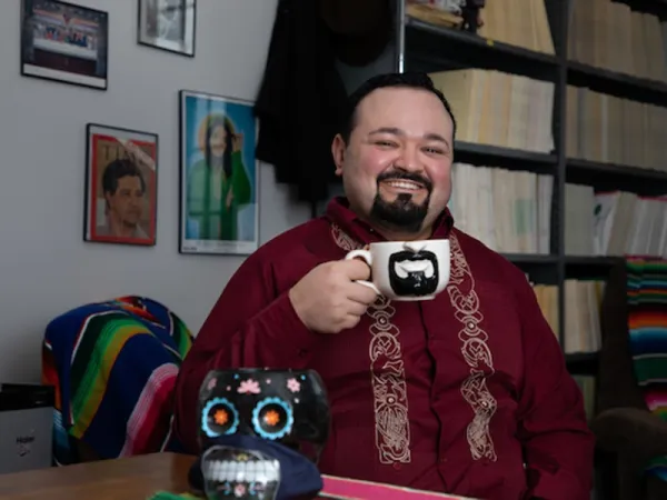 Erim Gomez sitting at a desk