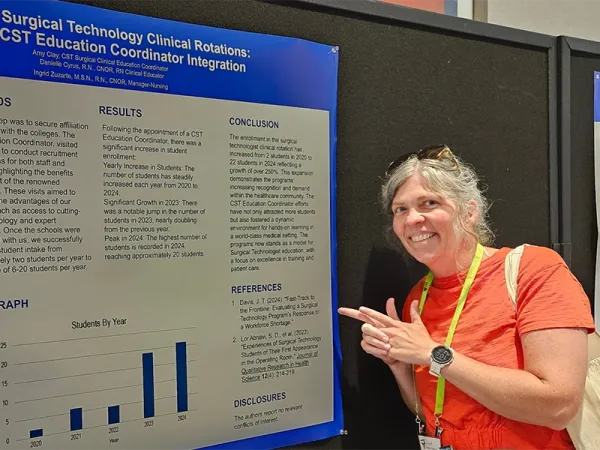 Jill Davis with her poster at a conference.
