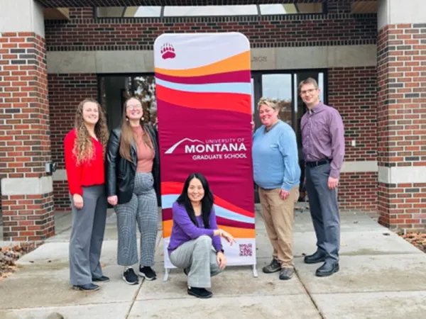 Graduate school team in front of davidson honors college