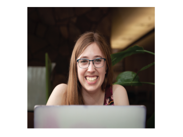 Girl smiling up from laptop