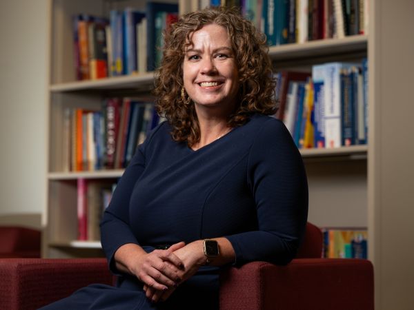 a portrait of dr. anisa goforth sitting in an office space