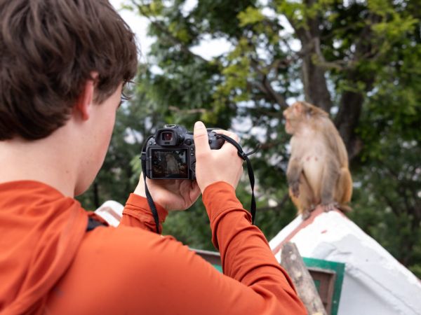 Noah Epps taking a photo of a monkey in Nepal