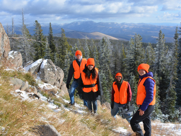 A group of students installs monitoring equipment in the mountains