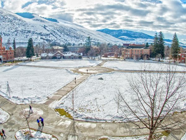 The sun shines on the Oval covered in a light layer of snow