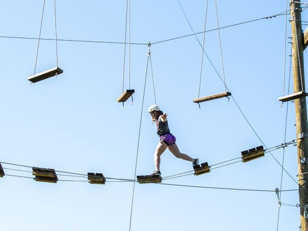 Student balancing on a high rope