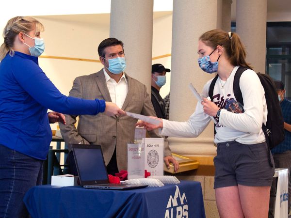 A UM business student chats with two potential employers. 