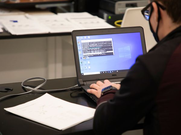 A student works at a computer.