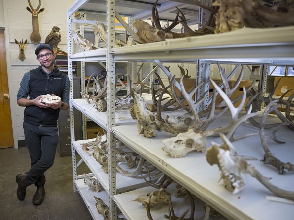 A picture of Connor Meyer holding a wolf skull.