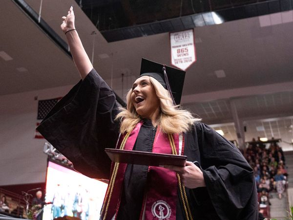 A UM student celebrates graduating. 
