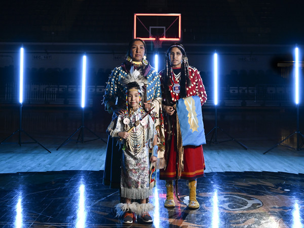 Photo of Holly Old Crow with her kids in regalia