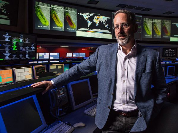 A photo of Jay Famiglietti in front of monitors. 