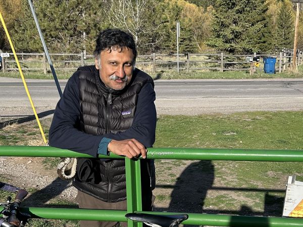 A picture of Bharath Sriraman leaning on a fence.