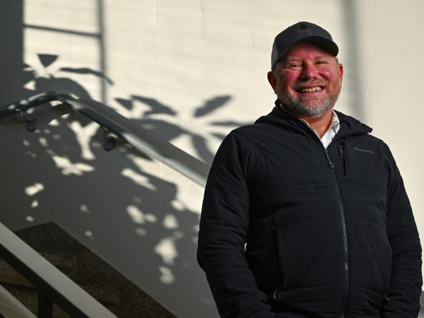 Dr. Cory Cleveland stands for a portrait