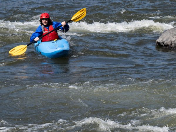 A student in UM’s whitewater kayaking class paddles through faster moving water during the class’s first day on moving water at Sha-Ron Fishing Access Site on the Clark Fork River.