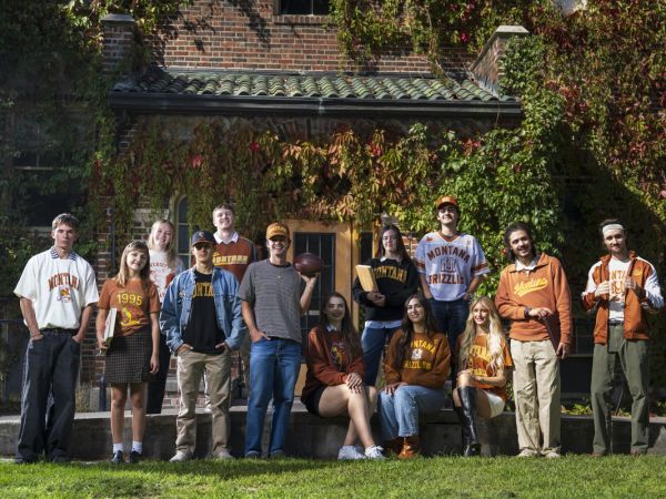 A group of college-aged students pose in a wide variety of clothing items and accessories from the University of Montana's limited-run vintage line.