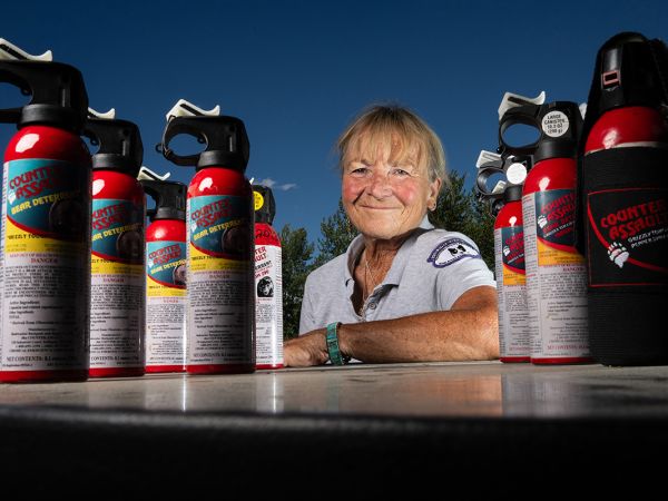 A picture of Carrie Hunt with cans of bear spray.
