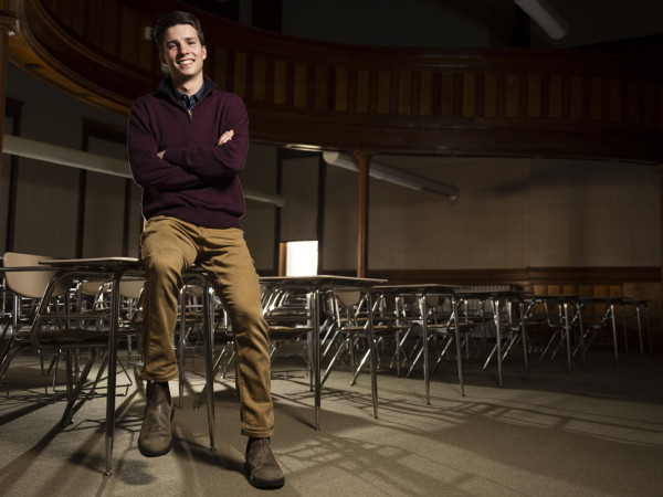 University of Montana student Buddy Wilson poses for a photo in an empty classroom.