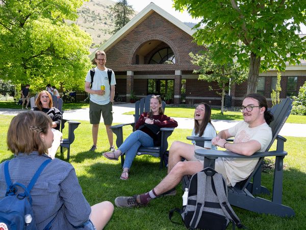 Students mingle and laugh outside the Davidson Honors College.