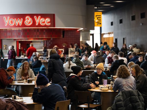 Students eat lunch inside the Lodge Dining Center at the University of Montana campus in front of one of the seven micro-restaurants featured.