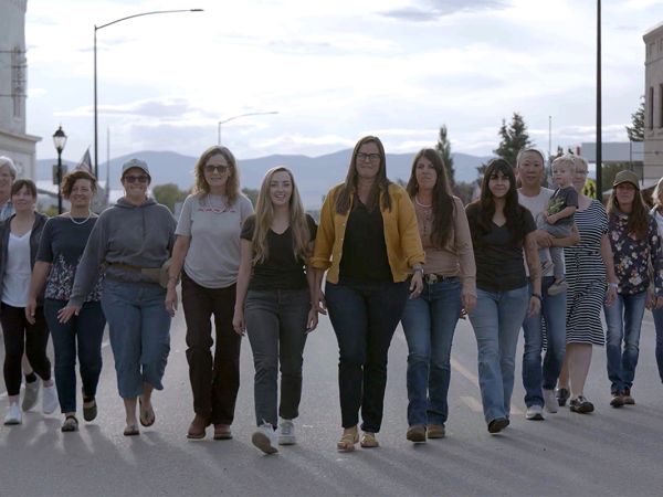 A picture of women walking together down a street.