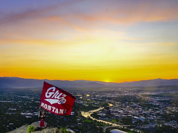 Monte flies a University of Montana Griz flag overlooking Missoula at sunset.