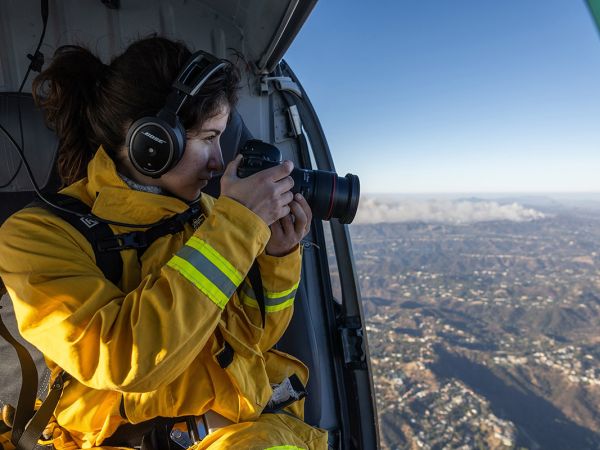 Brontë Wittpenn takes a picture from a helicopter in flight.