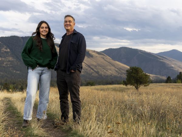 An image of UM communication studies professor Stephen Yoshimura and his undergraduate research assistant Jess Reilly standing on a trail in Missoula. 